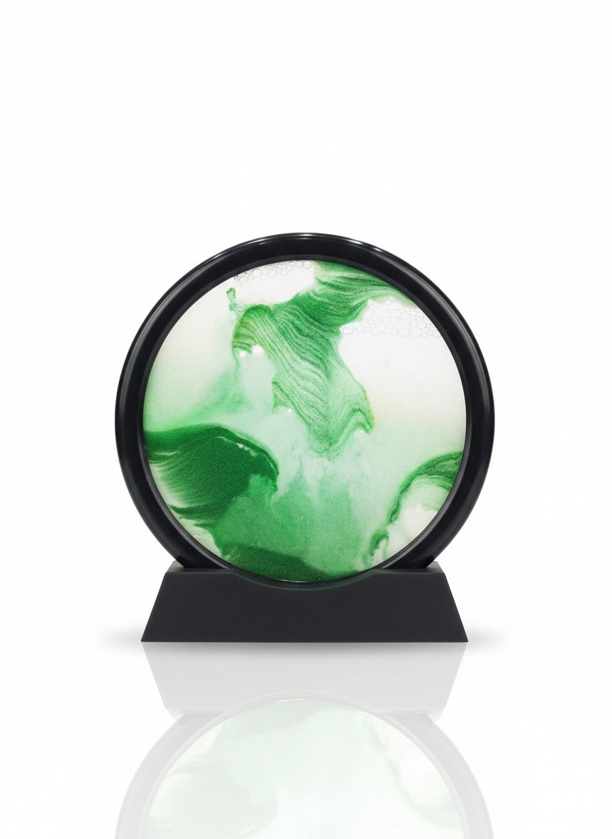 Circular dynamic moving sand art picture with black frame, showing vibrant green and white flowing sand patterns on a white background.